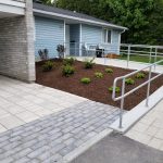 Plant bed, concrete ramp with handrail, and precast concrete pavers at Marlborough Towers